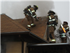 Firefighters on the Roof of  Structure  on Adams Street