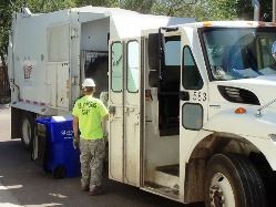 Public Works Staff Member Picking Up Curbside Garbage