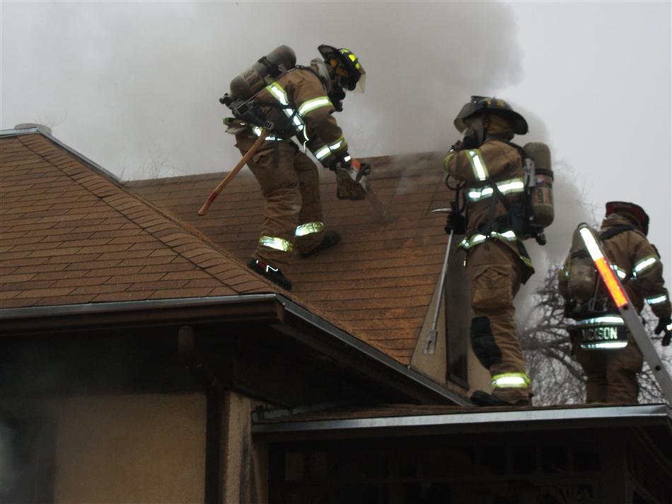 Firefighters on the Roof of  Structure  on Adams Street