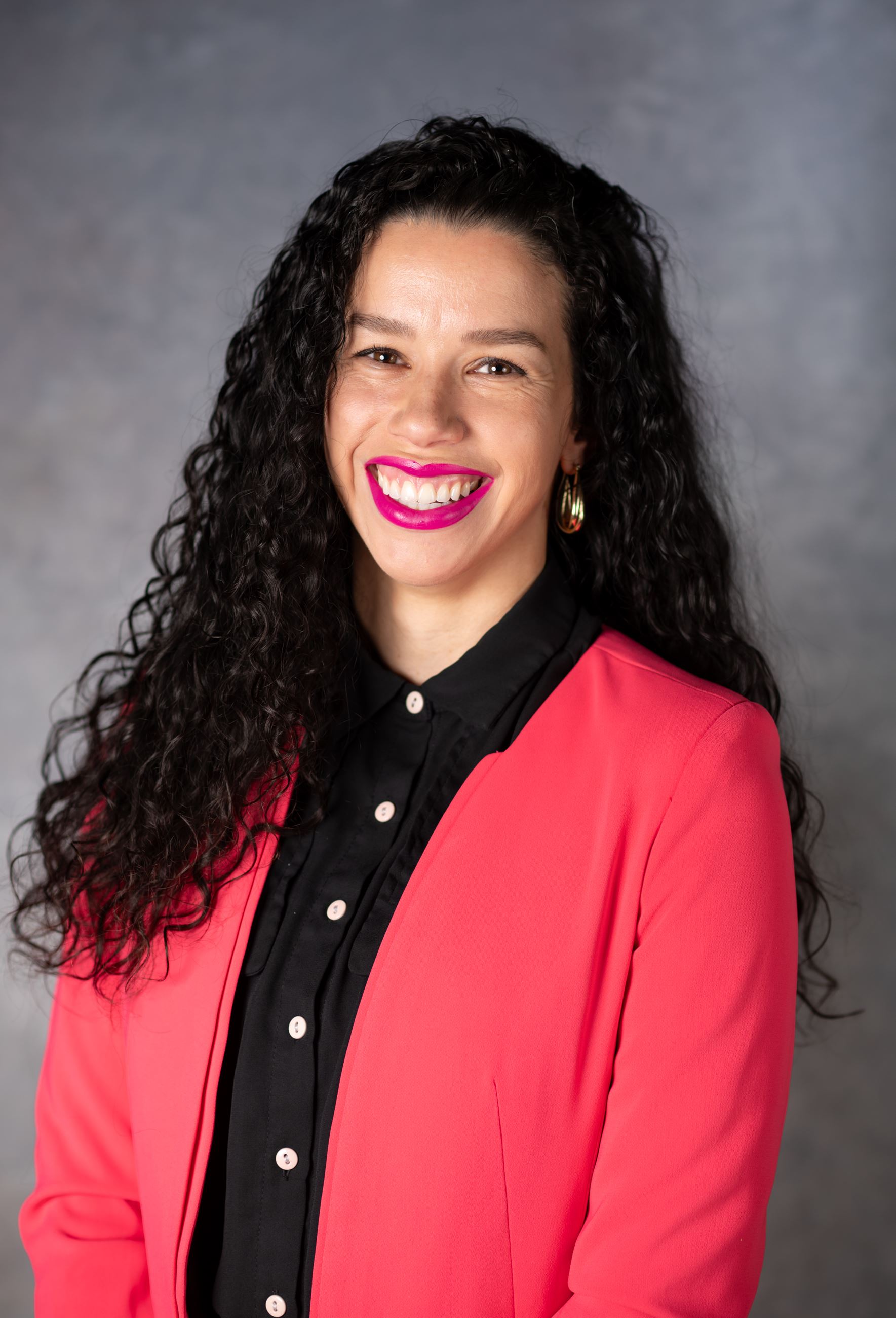 Ariana Lorenzo pictured wearing a black top and pink blazer.