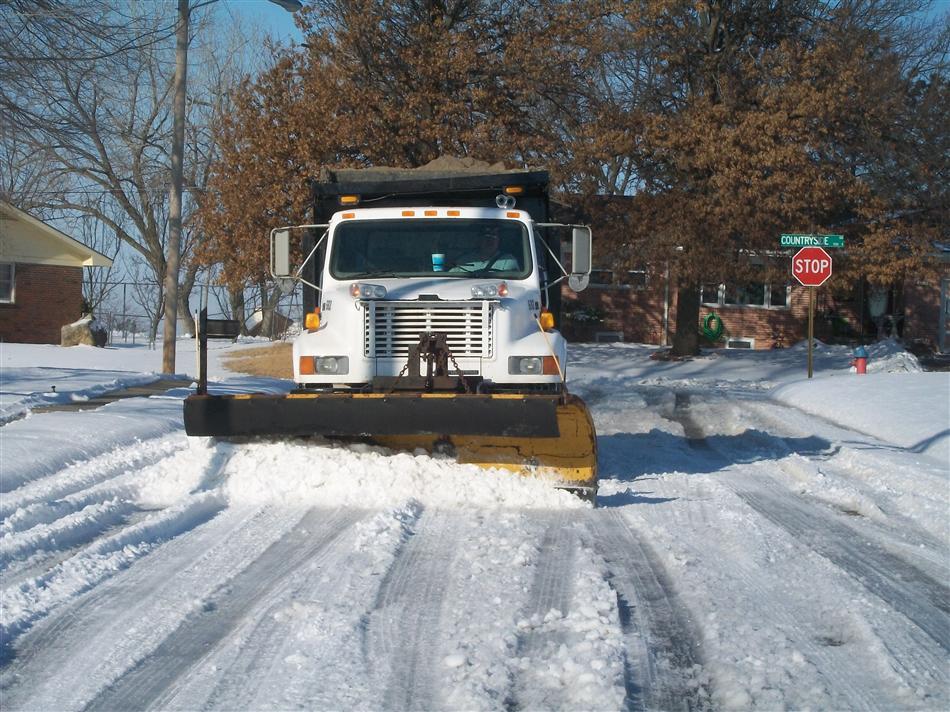Snow Plow Scraping Snowy Street